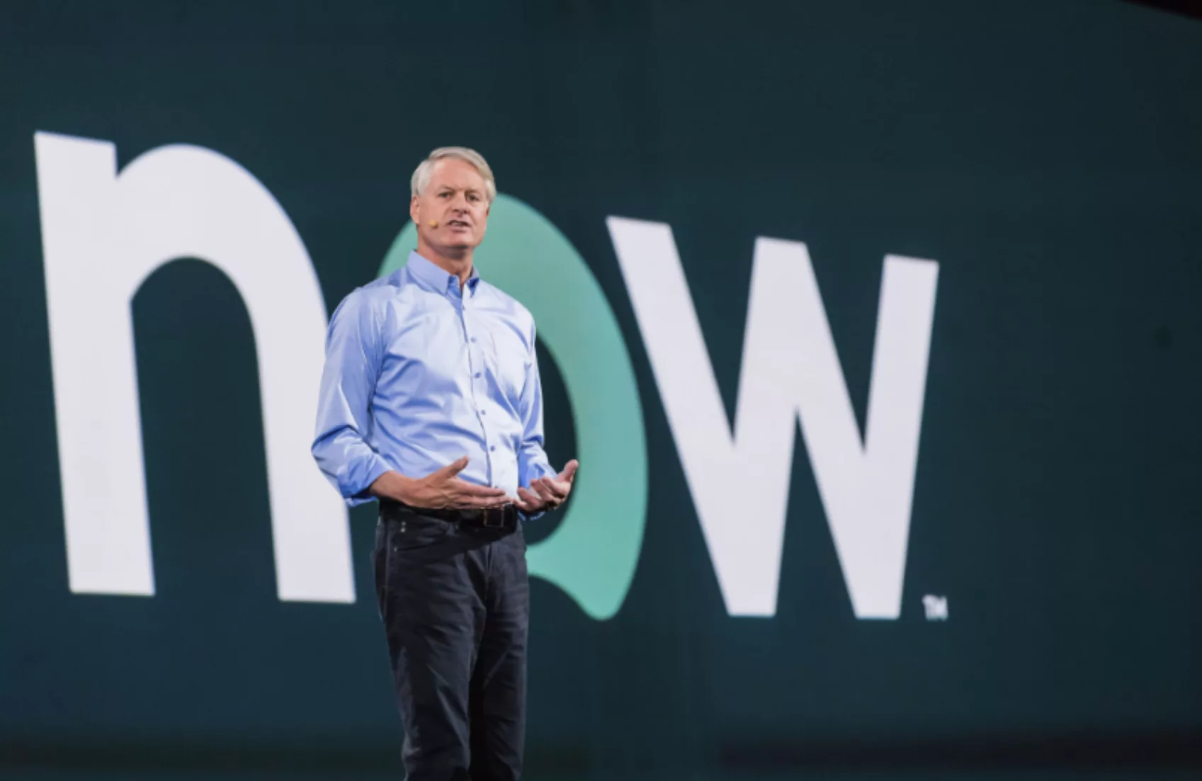 A speaker onstage at a Service Now conference