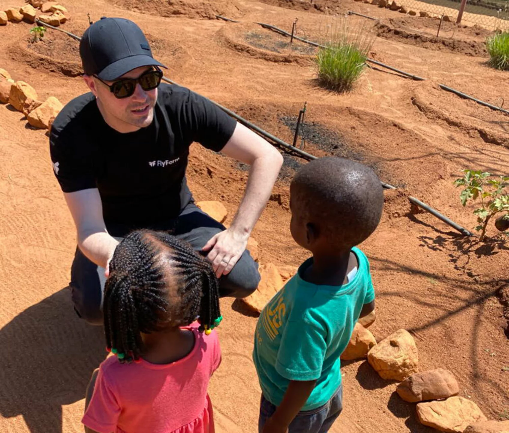 FlyForm's Steve Williams speaks with some local children who've benefitted from Ndlovu's malnutrition treatment.