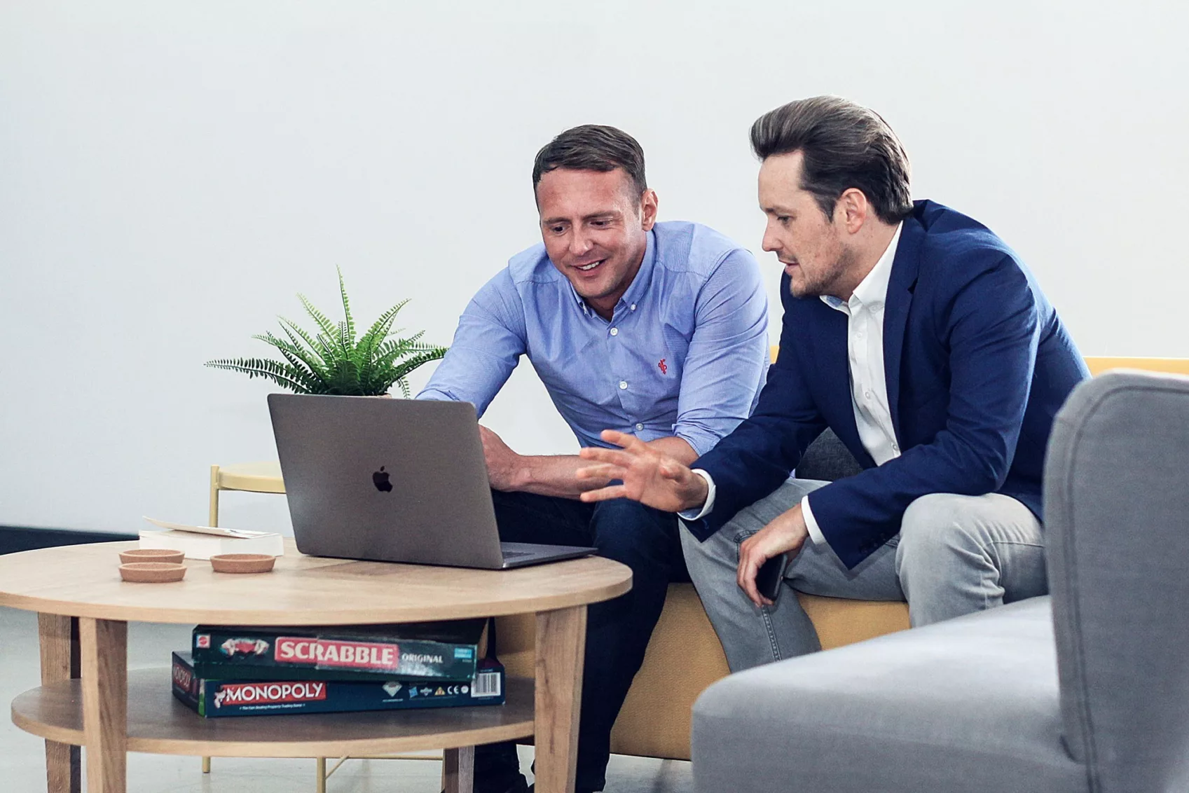 Phil and Arron in discussion whilst sat at a desk