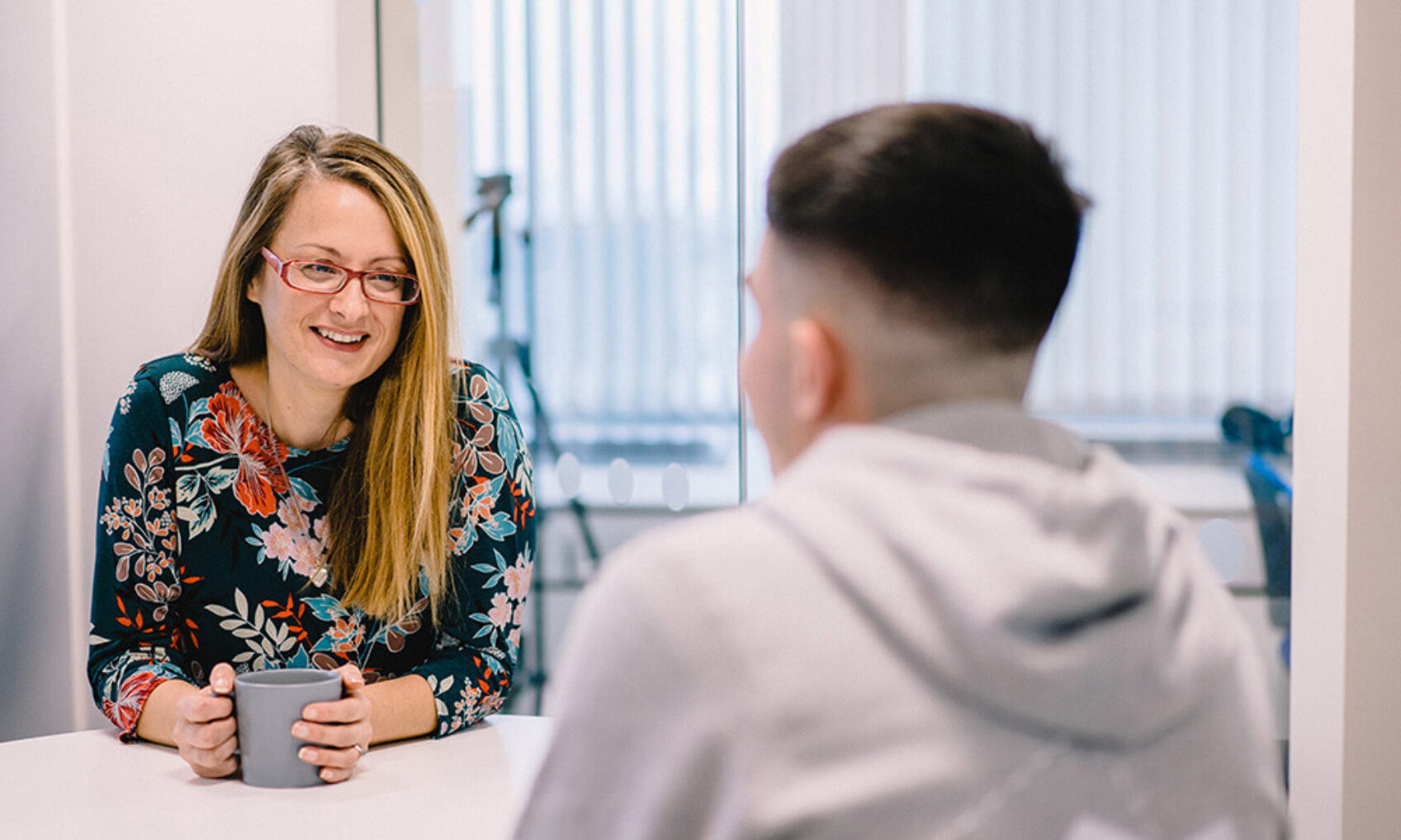 FlyForm's Engagement Manager, Emma Wilcox, speaks to a colleague over a cup of coffee.